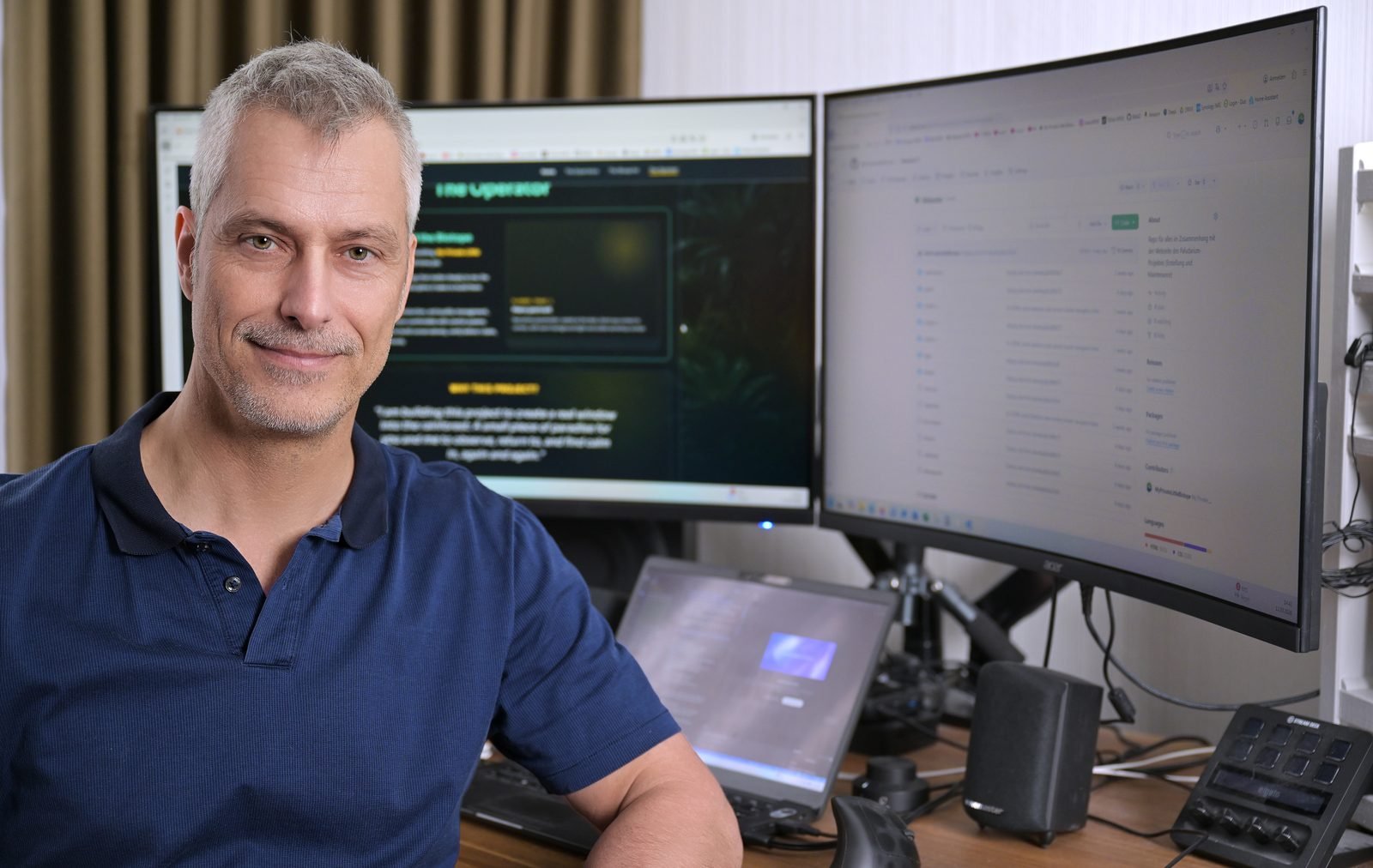 Portrait of Kai seated at the desk in a warm workshop setting